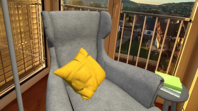 A virtual armchair with a yellow cushion placed by a real window in mixed reality.