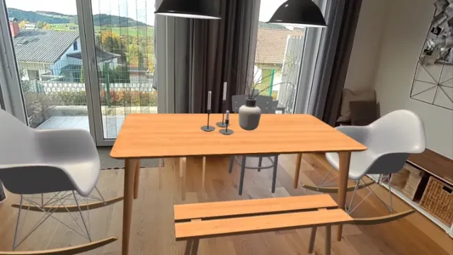 Relize in mixed reality: a virtual dining table, chairs and lamps placed in a real living room.